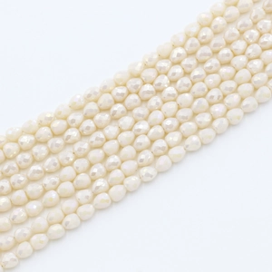 Macro shot of 4x5mm cream white faceted strawberry drop beads for DIY jewelry making