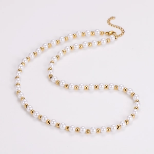 Close-up of vintage white pearls and gold beads necklace with adjustable lobster clasp