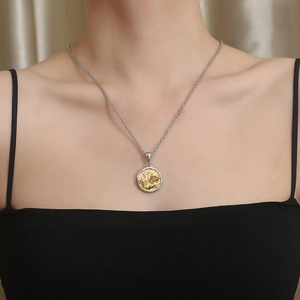 Detailed view of silver and gold stainless steel necklace with dice and poker pendant