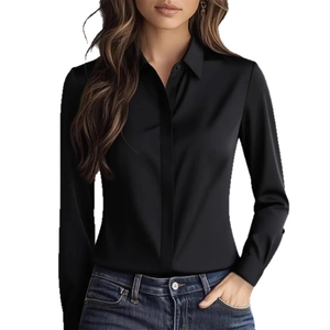 Elegant black long-sleeve satin shirt for women paired with dark blue denim jeans