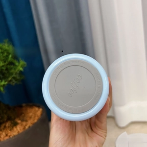 Close-up of non-slip coffee mug bottom with silicone pad and care instructions