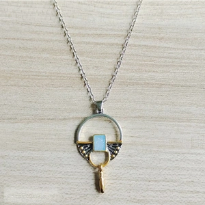 Detailed close-up of a vintage boho necklace with blue moonstone and mixed metal pendant
