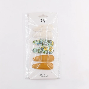 Detail of 6pcs teardrop hair clips with beige lace, floral patterns, and mustard fabric