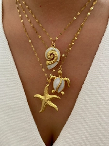 Detailed layered golden ocean necklaces featuring starfish, turtle, and shell pendants