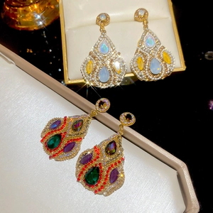 Detailed view of teardrop crystal earrings with shimmering stones in gold setting
