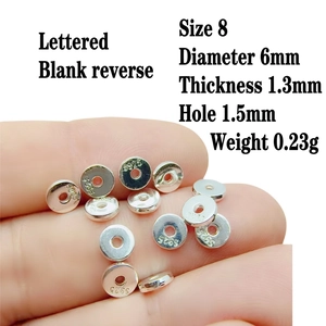 Close-up of S925 sterling silver spacer beads 6mm with engraved hallmarks for DIY jewelry