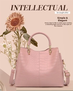 Detail of soft pink crocodile embossed leather tote bag with gold metal hardware