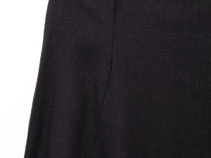 Close-up of black linen blend fabric showing detailed weave and professional stitching