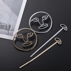 Golden and silver hollow abstract face hair sticks made of polished alloy metal