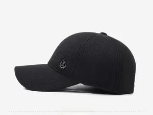 Side view of black winter cap showing wool texture and silver shield metal badge detail