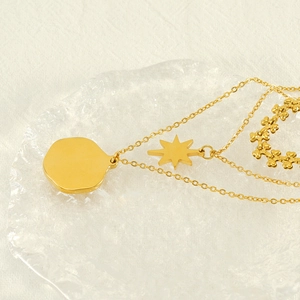 Gold multi-layer necklace featuring star pendant and heart-shaped chain design