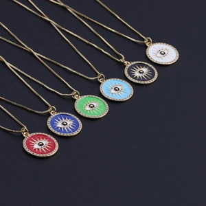 Detail of colorful enamel evil eye pendants on gold-plated chains in various vibrant colors