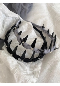 Detailed shot of bow-knot headbands with rhinestones and spikes in black and grey