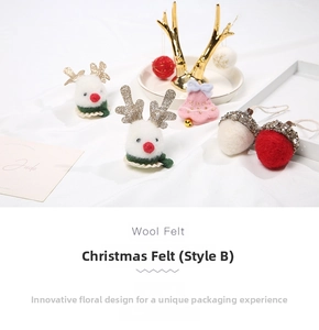 Detailed view of handmade wool felt Christmas ornaments including reindeer and acorns