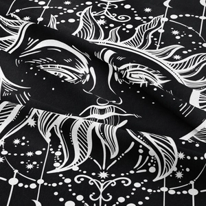 Close-up of bohemian sun and moon tapestry showing fine fabric texture and sharp prints