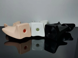 Detail shot of black, white and beige PVC mannequin heads on a reflective mirror surface