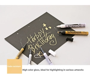 Sakura Pen-touch 2.0mm gold and silver markers on black card showing opaque ink effect