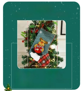 Detail of burlap Christmas stocking with reindeer plush and dimensions 30x24cm