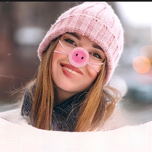 Detail view of pink handmade knit pig nose warmer for winter with soft wool texture