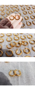 Detail of gold spiral textured hoop earrings with a sophisticated metallic finish