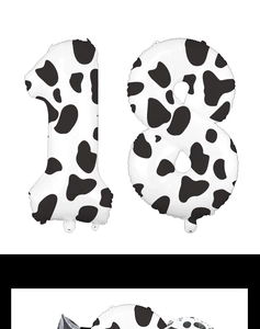 Close-up of number 18 foil balloons with black and white cow print for birthday party decor