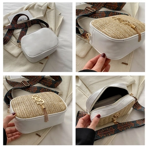 Detail view of woven straw flap bag with golden logo and jacquard wide shoulder strap