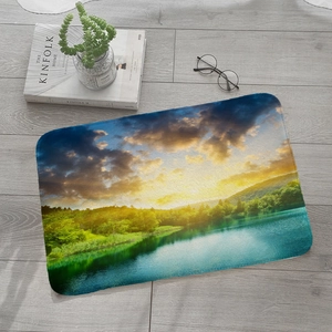 Absorbent flannel rug with sunset lake forest print placed on a grey wooden floor