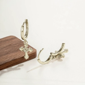 Silver coffee gold iris cross pendant hoop earrings for men and women on wooden block