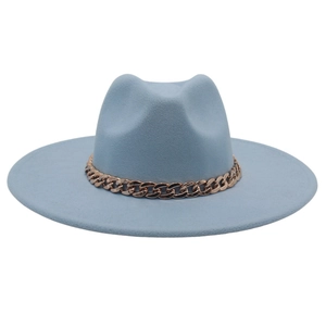 Detail of light blue fedora hat featuring a chunky gold acrylic chain on the brim