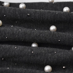 Dark grey knitted beanie with elegant pearls and metal studs for winter warmth