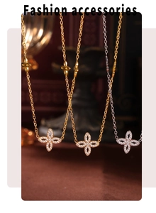 Close-up of four-leaf flower pendant with sparkling zircon in gold and silver plating