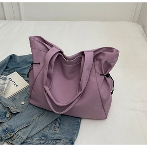 Close-up of minimalist purple nylon tote bag with adjustable black drawstring details