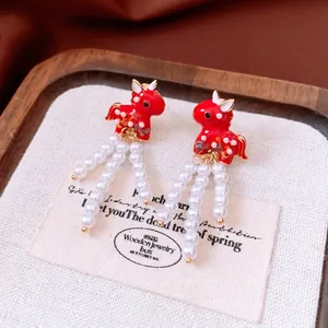 Red enamel horse earrings with white pearl tassels in a vintage New Year style
