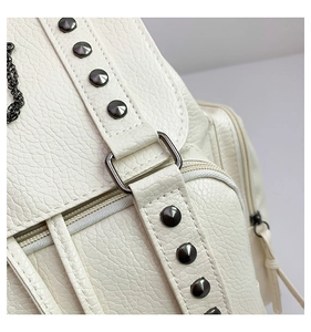 Close-up of white lychee pattern leather backpack with gunmetal rivets and metal zipper