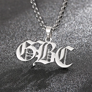 Close-up of a silver dumbbell-shaped gothic alphabet pendant on a stainless steel chain