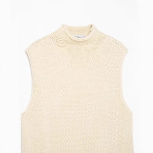 Chic cream white high neck sleeveless knitted vest with asymmetrical design for women