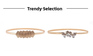 Détail de chaînes de taille dorées avec papillon en strass et breloques en éventail
