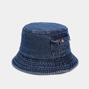 Detail of denim bucket hat featuring side pocket with brass button and fine stitching