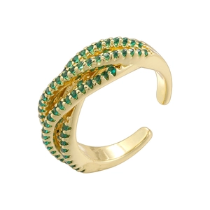 Detailed view of criss-cross golden ring featuring micro-pave green crystals for women