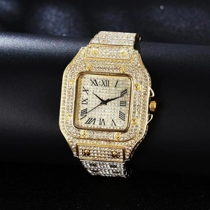 Close-up of golden square watch with sparkling rhinestones and Roman numerals dial