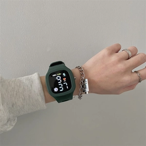 Close-up of a green LED digital watch for kids with square touch screen on a wrist