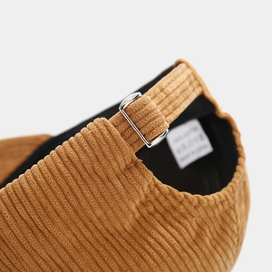 Détail de la boucle en métal sur casquette en velours côtelé avec texture de qualité