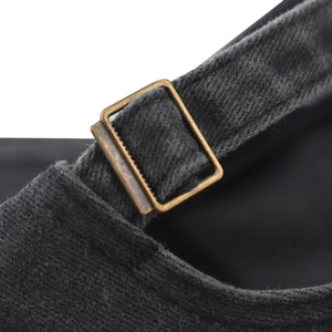 Detailed view of vintage bronze buckle and adjustable strap on washed cotton baseball cap