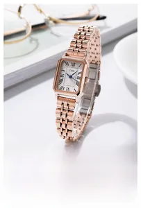 Macro view of a GEDI square rose gold watch dial with roman numerals and blue hands