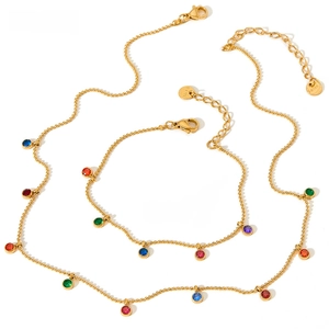 Detail of gold beaded necklace and bracelet set with colorful round zircon pendants