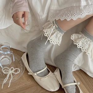 Grey balletcore lace crew socks with white frills and bows for a sweet lolita aesthetic