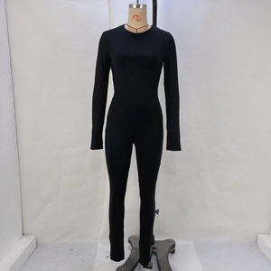 Detail of slim fit black long sleeve jumpsuit with high elastic fabric and contouring fit
