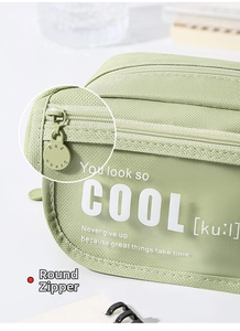 Close-up of smooth circular metal zipper and transparent window on light green pencil case
