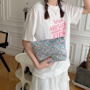 Detailed view of the floral cotton fabric texture and pattern on the portable pouch