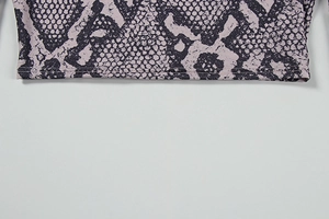 Detail of snake skin print yoga set featuring double-needle hem stitching and elastic fabric